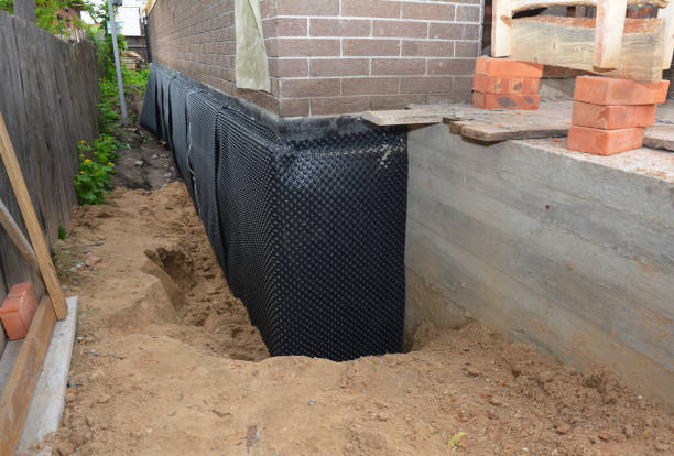 Happy homeowners after waterproofing job in Tipton